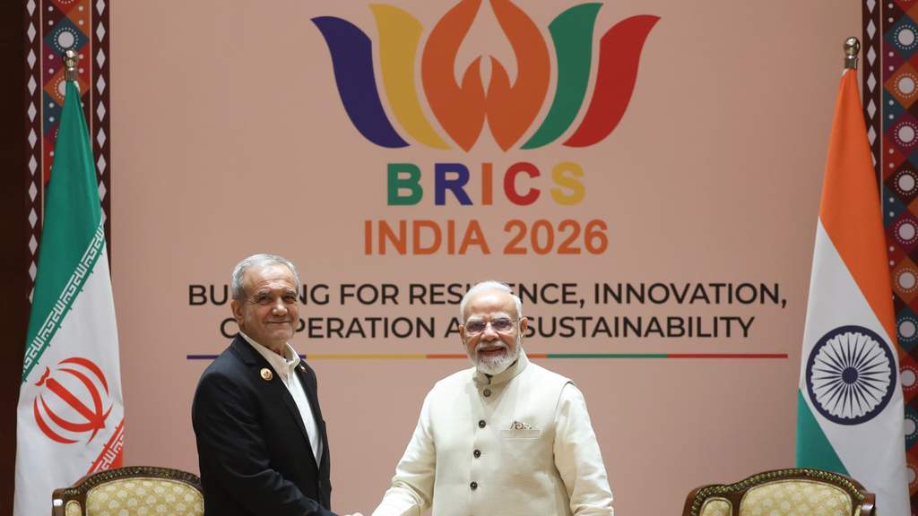 Iranian President Masoud Pezeshkian and Indian Prime Minister Narendra Modi greeting each other warmly during the BRICS Summit in New Delhi.