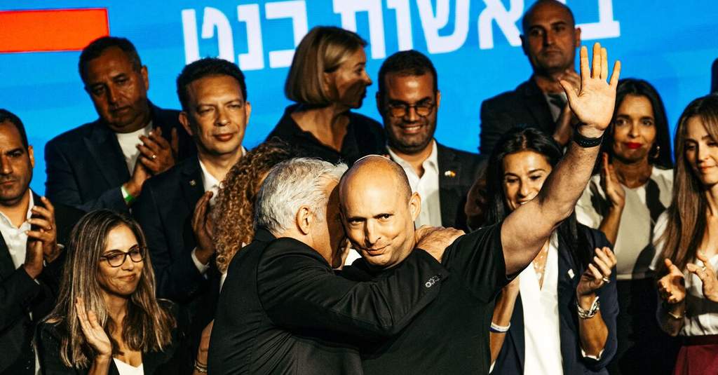 Israeli political figures speaking at a press conference in Jerusalem against the backdrop of the city skyline.