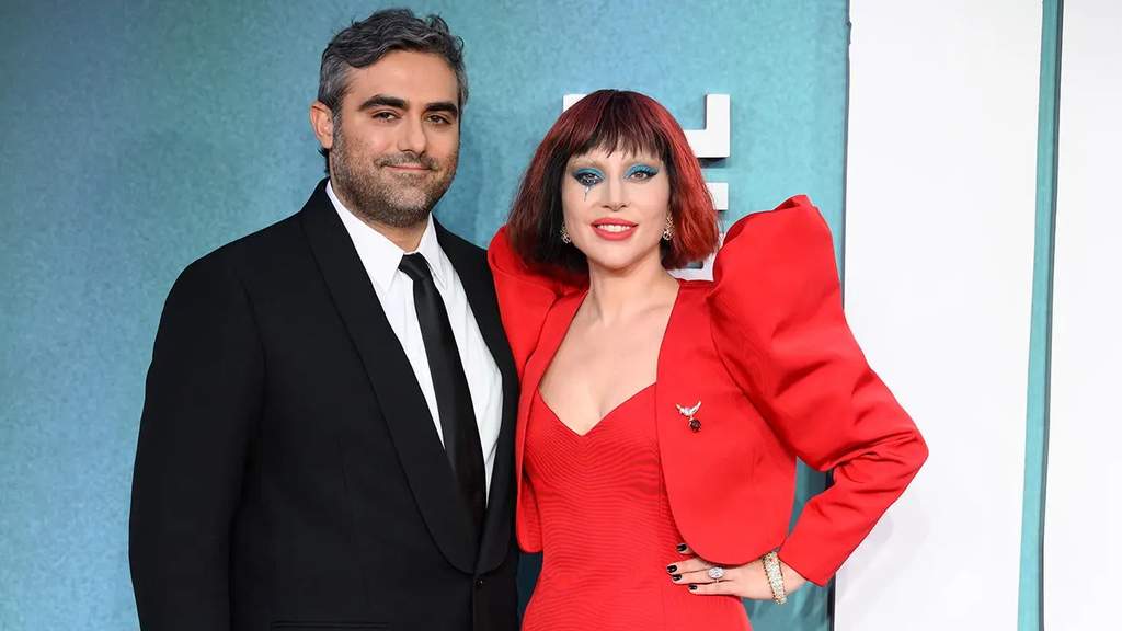 Lady Gaga and her fiancé Michael Polansky posing together on a red carpet event prior to welcoming their first baby.
