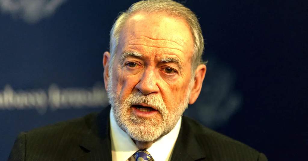 US Ambassador to Israel Mike Huckabee speaking at a formal diplomatic event, captured during a live press briefing.