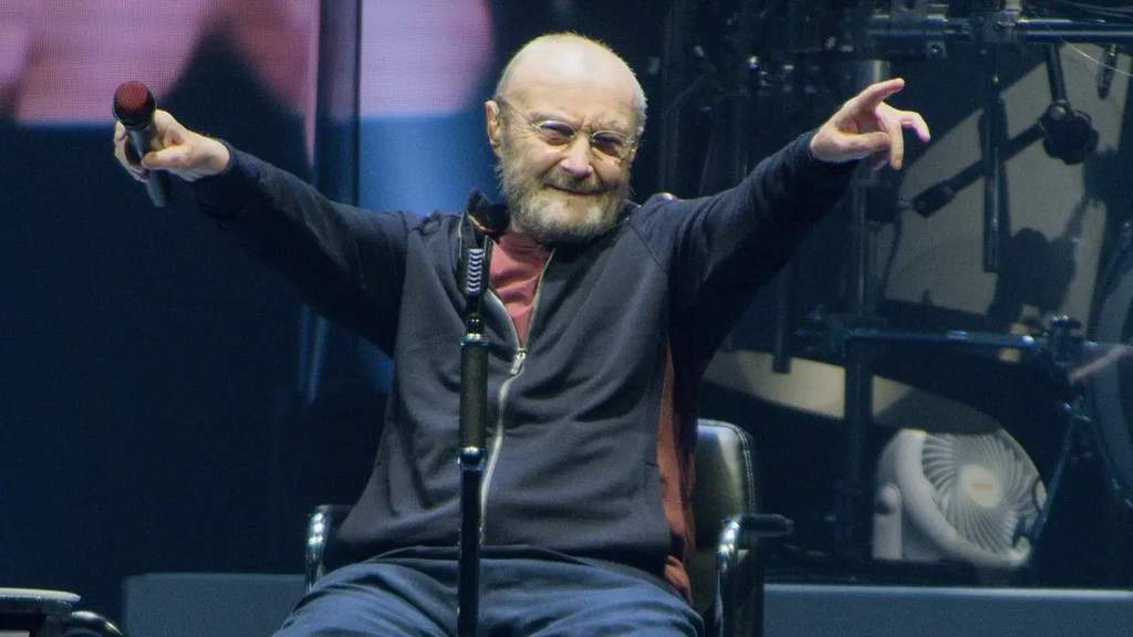 Music icon Phil Collins smiling while attending a high-profile public appearance during his legendary career.