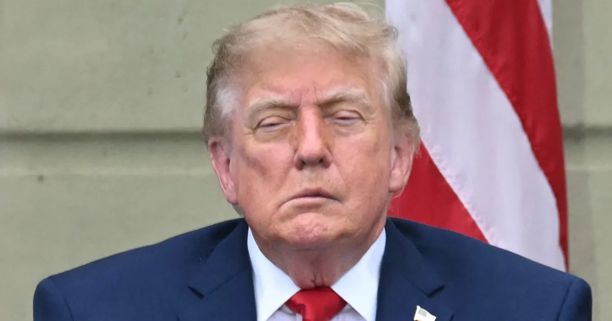 President Donald Trump sitting on stage during the September 11 memorial service at the Pentagon, where his appearance drew public attention.