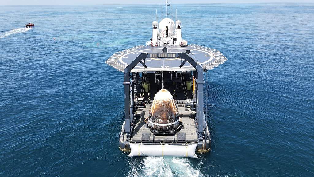 The SpaceX capsule recovery vessel MV Shannon stationed at sea, highlighting its specialized stern crane and medical facilities for astronaut retrievals.
