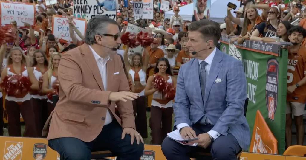 Senator Ted Cruz standing on the set of ESPN College GameDay in Austin wearing a burnt orange blazer while surrounded by a large crowd.